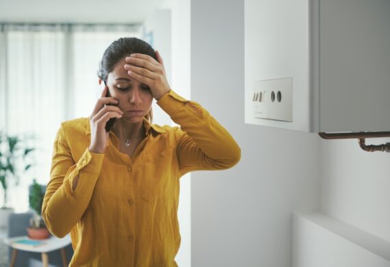 worried and stressed woman calling a technician for boiler breakdown services